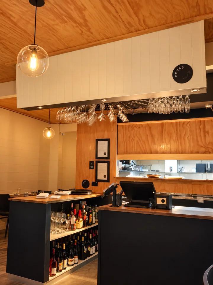 Warm cafe interior with pendant lights and bar